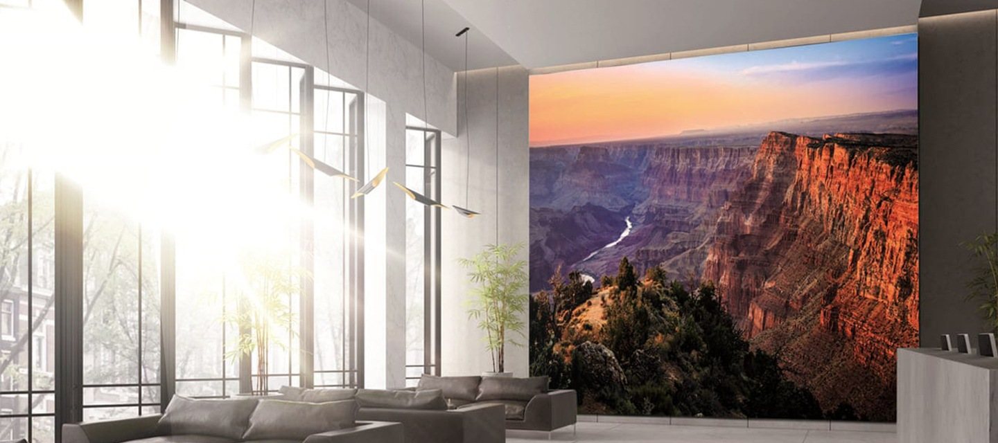 A large Samsung display showing a canyon landscape in a bright room